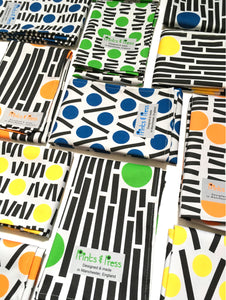 collection of colourful geometric teatowels on white background